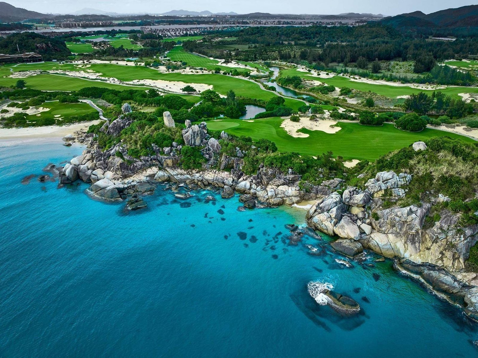 Seaside golf course among rocks and turquoise water